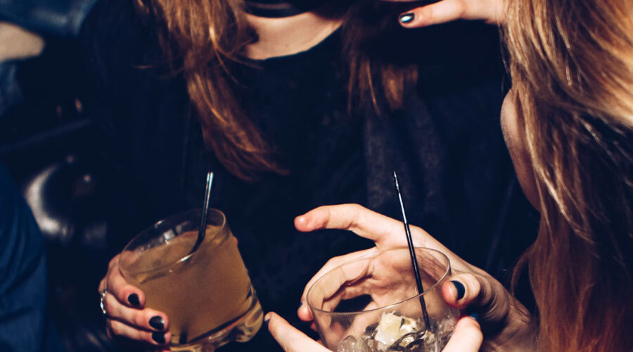 Two women enjoy a vodka cocktail at a social event