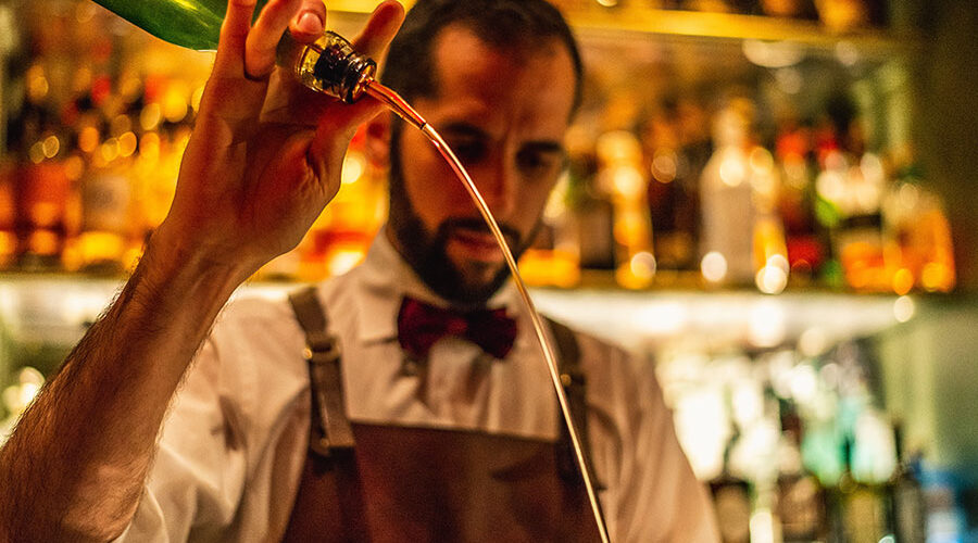 A bartender pours with flair